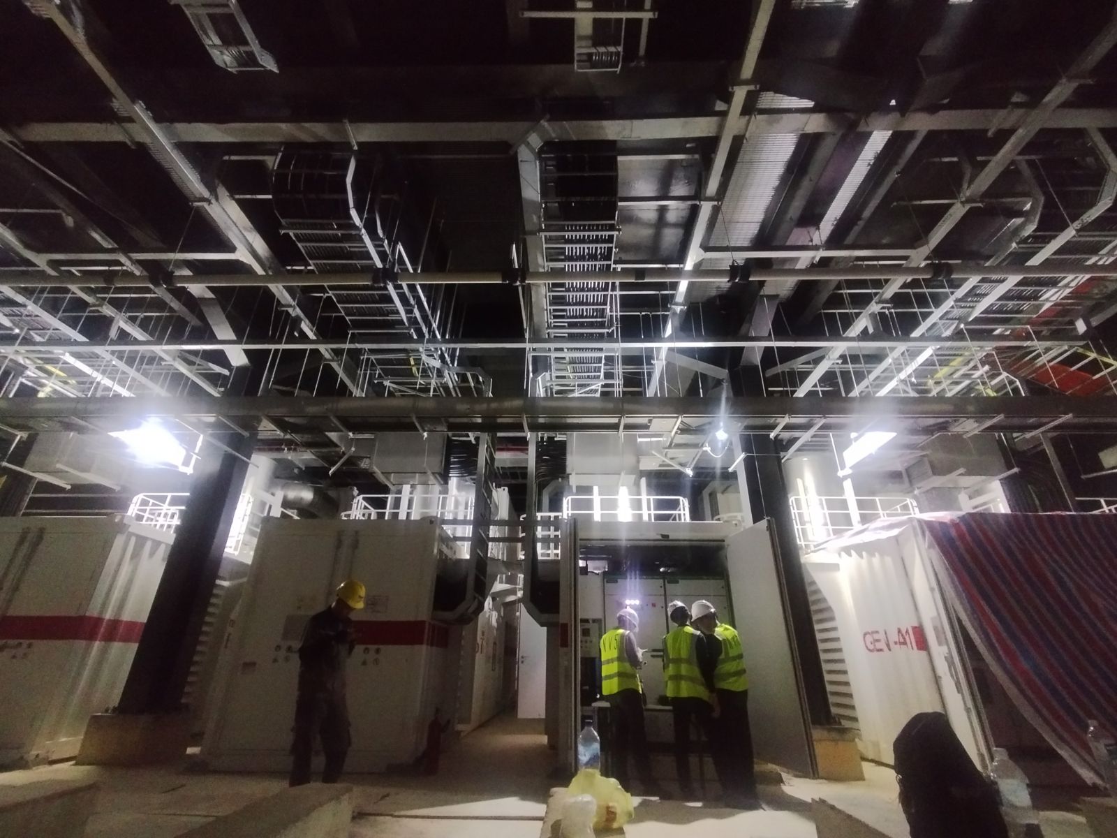 Inspection team at open LV switchgear in a power plant room